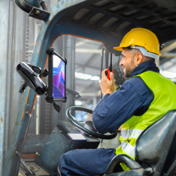 man wearing vest and hard hat in forklift with mounted lenovo tab k11